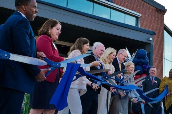 Shenandoah University officials; Cecil Pruitt, Jr.; and members of the Hazel family cut a ribbon to celebrate the opening of Hazel-Pruitt Armory.